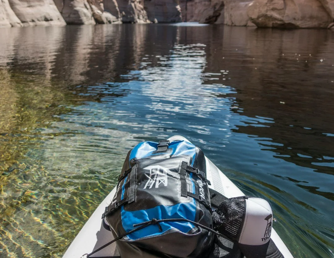 Paddler exploring crystal-clear water at golden hour